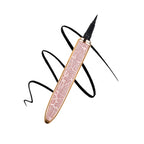 Rose gold glitter self-adhesive eyeliner pen with a fine black tip over a black ink swirl on a white background.