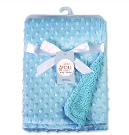 Light blue, plush baby blanket with a textured dot pattern, tied with a white ribbon and Just To You brand tag.