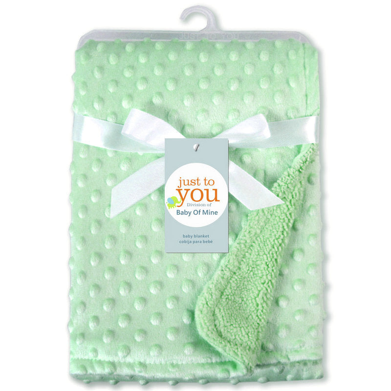 Mint green, textured dimple-dot baby blanket with a white ribbon, soft fuzzy lining, and a Just To You brand tag.