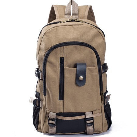 Tan canvas student backpack with black trim, multiple zippered compartments, side mesh pockets, and buckled straps.