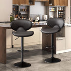 Two modern black faux leather bar stools with curved backrests, swivel seats, and adjustable height pedestals.