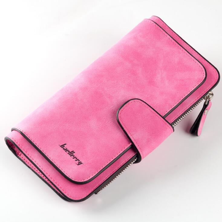 Hot pink, suede-finish women’s wallet by Baellerry with a snap closure, side zipper, and black contrast trim.
