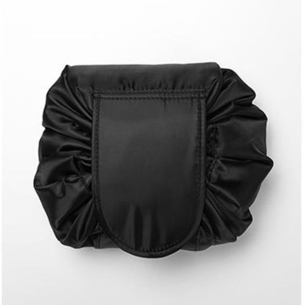 Black, drawstring-style cosmetic bag made of smooth, satin-like material, isolated against a white background.