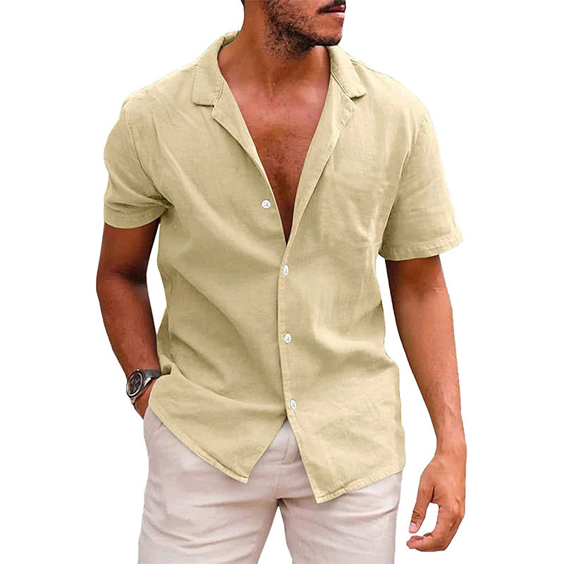 A tan, short-sleeve button-down beach shirt with a camp collar, made of a textured, linen-like fabric.