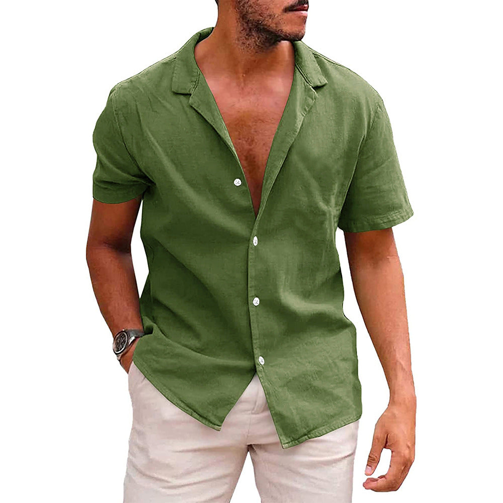 A man wearing an olive green, short-sleeved, button-down linen beach shirt with a notched collar.