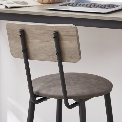Grey PU leather bar stool with backrest, wooden back panel, and black metal frame under a matching bar table.