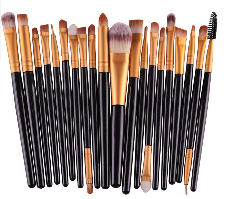 Digitaldistribution375: A set of makeup brushes with black handles, gold ferrules, and soft brown and white bristles.