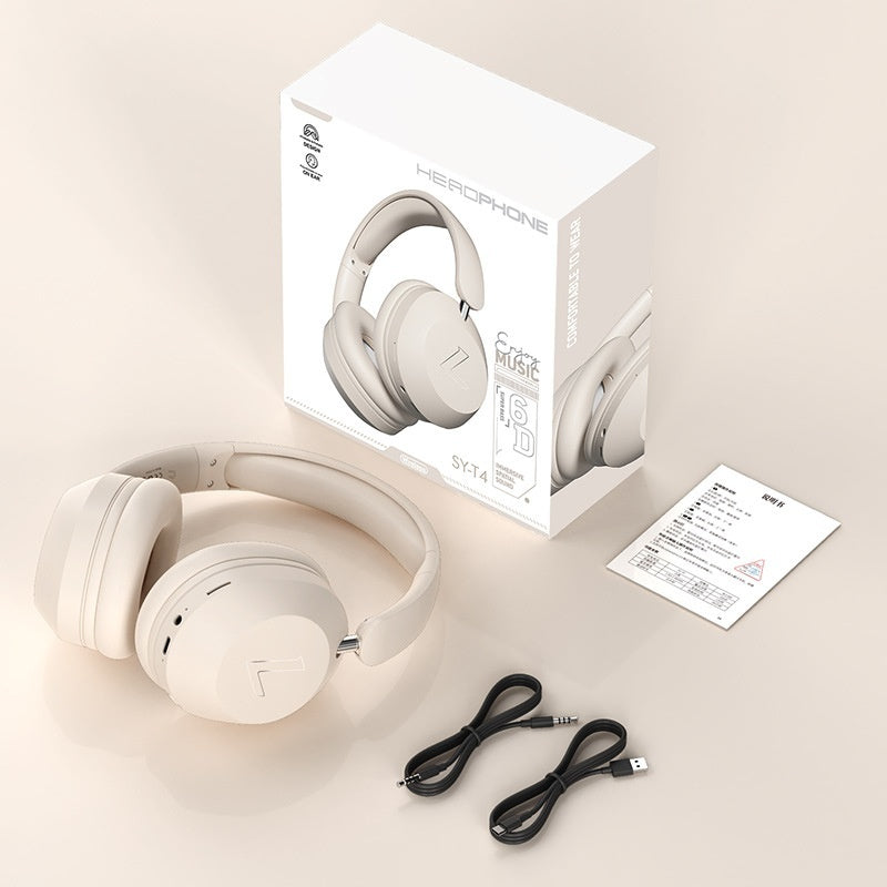 Beige wireless Bluetooth over-ear headphones, matching packaging box, user manual, and two black charging/audio cables.