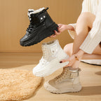 Fleece-lined, windproof high-top platform boots in black, white, and beige with lace-up fronts and metallic side detail.