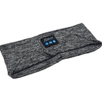 Grey heathered knit Bluetooth sleep headband with integrated control panel featuring playback and volume buttons.