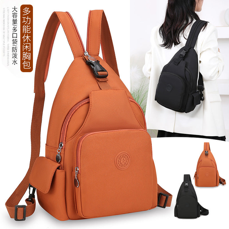 Orange and black waterproof nylon chest bags featuring multiple zippered pockets, adjustable straps, and side buckles.