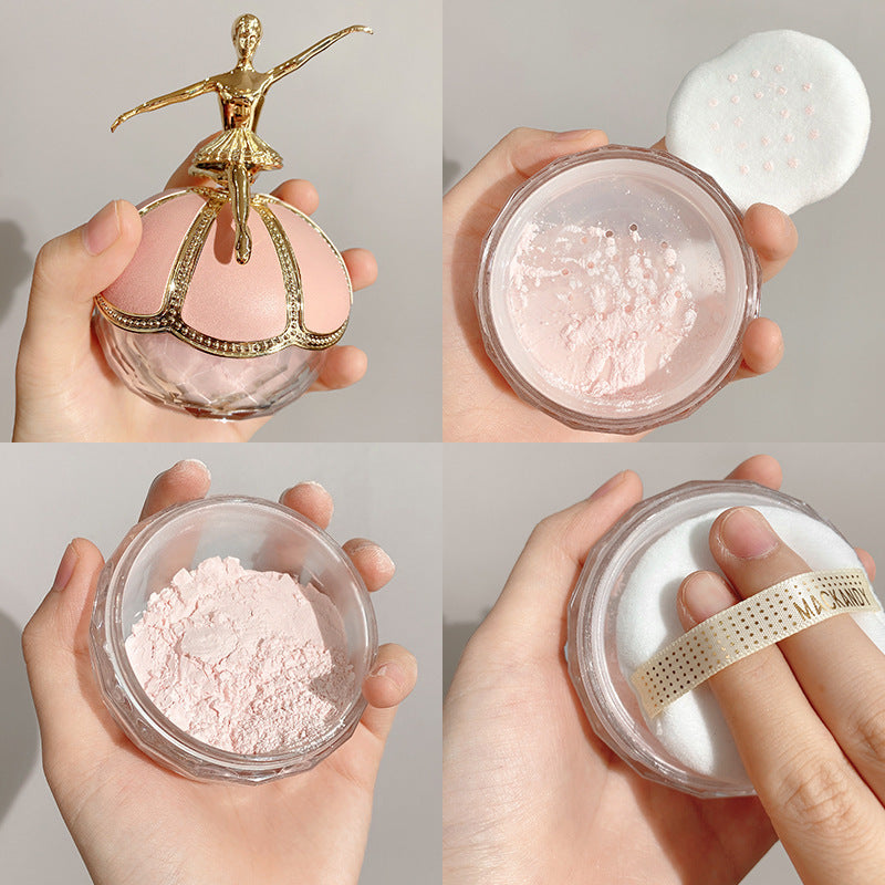 Pink Mac Andy finishing powder with a gold ballerina lid, glass jar, and soft applicator puff in hand.