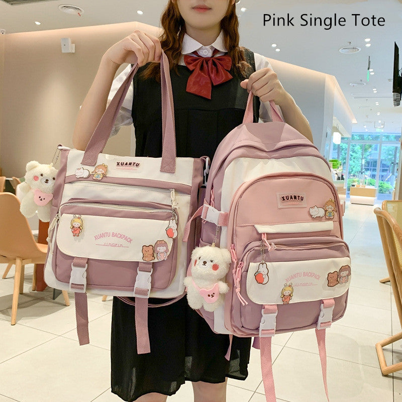 A person holding a pink and white Korean-style tote bag and matching backpack, featuring cute animal charms and pins.