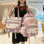 A person holding a pink and white Korean-style tote bag and matching backpack, featuring cute animal charms and pins.
