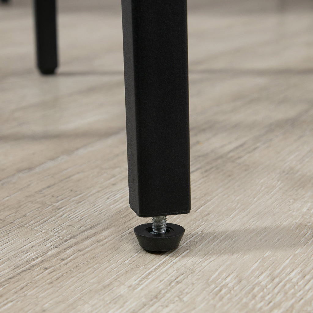 Close-up of a black metal furniture leg with an adjustable, protective floor leveling foot on a light wood floor.