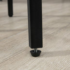 Close-up of a black metal furniture leg with an adjustable, protective floor leveling foot on a light wood floor.