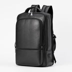 Black multifunctional leather business backpack with USB port, large capacity, and zippered compartments.