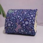 Blue floral and bunny print cotton baby nursing arm pillow with a soft, cream-colored interior lining.