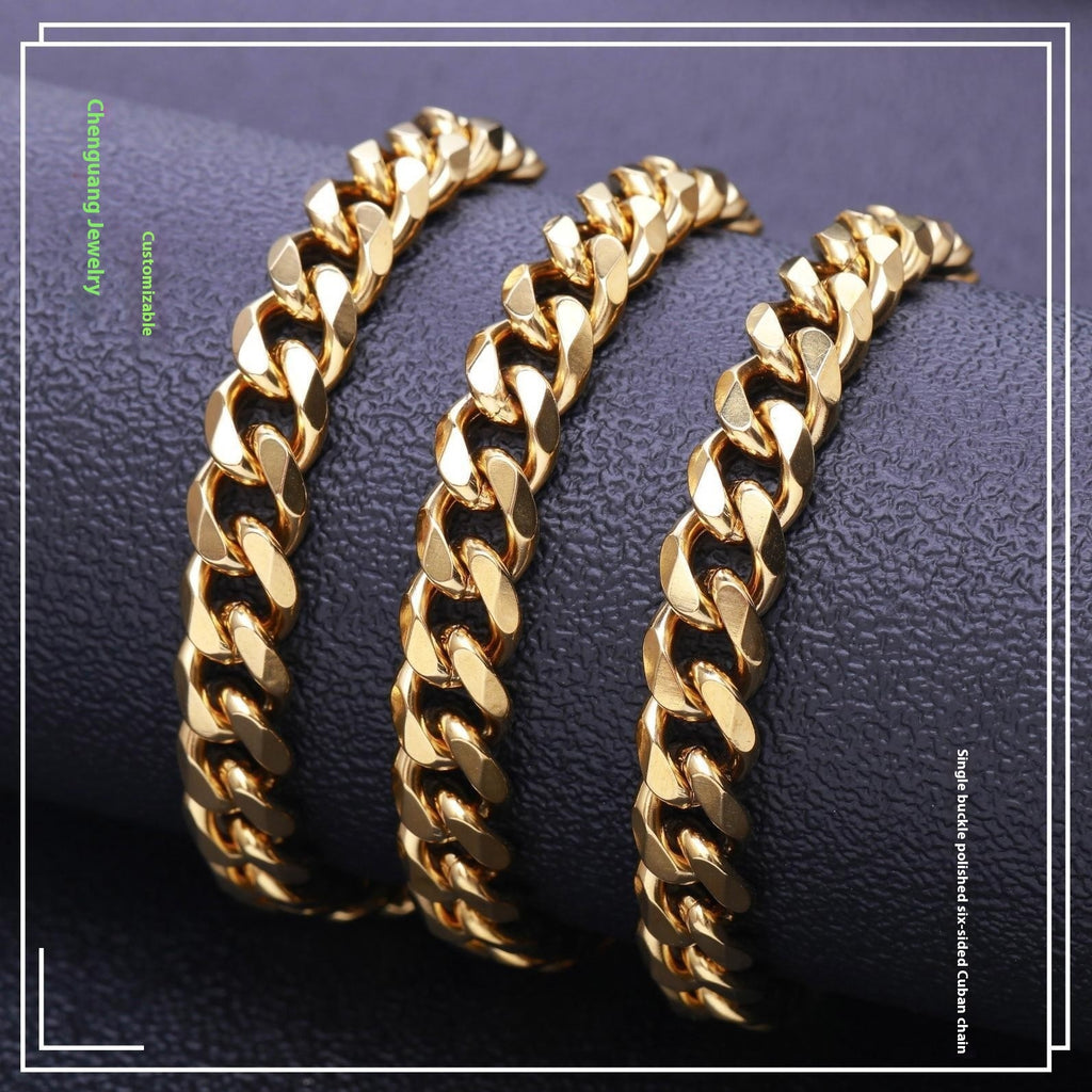 Gold-tone polished Cuban link chains displayed on a textured dark surface, featuring a classic hip hop style design.