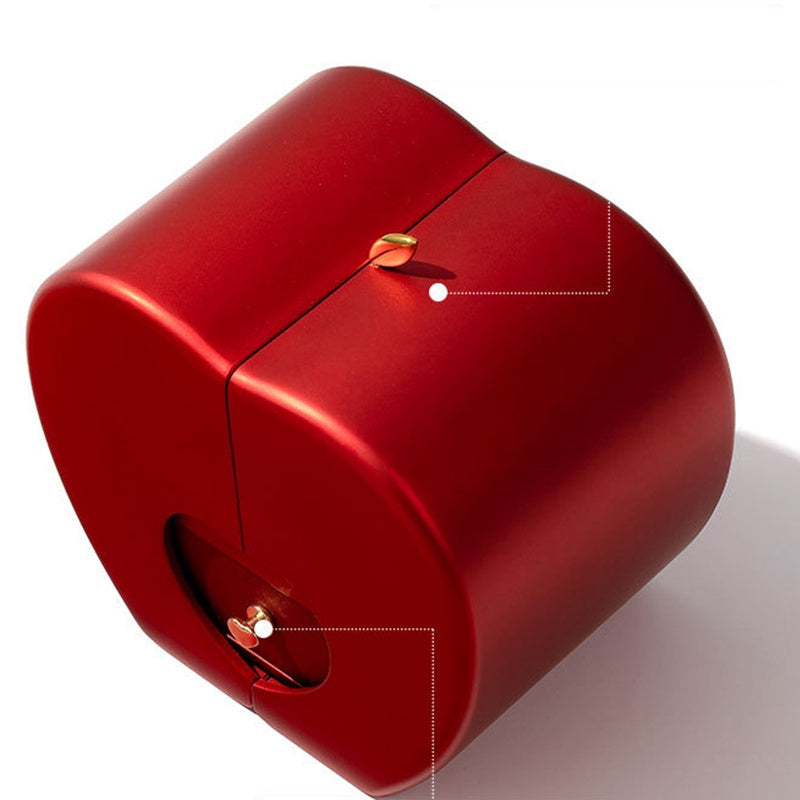 Red apple-shaped jewelry box with a matte finish, gold leaf clasp, and a small front pull tab on a white background.