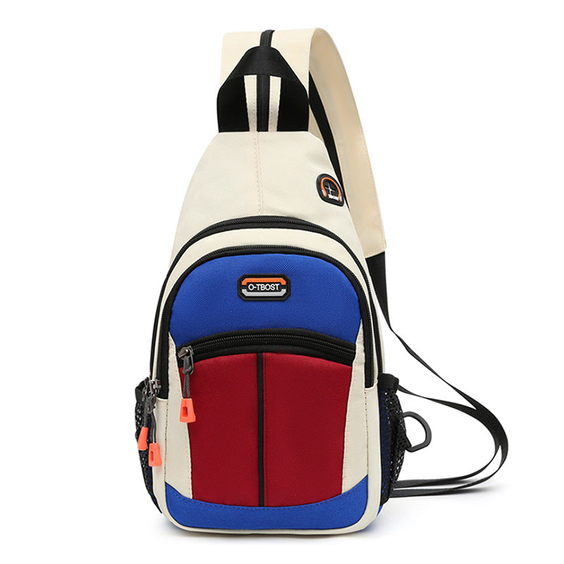 Multicolor sling backpack with cream, blue, and red panels, zip pockets, USB port, and adjustable strap.