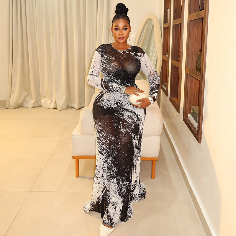 Woman wearing a sheer, black and white abstract print long-sleeved straight-tube maxi dress with a hip-skimming fit.