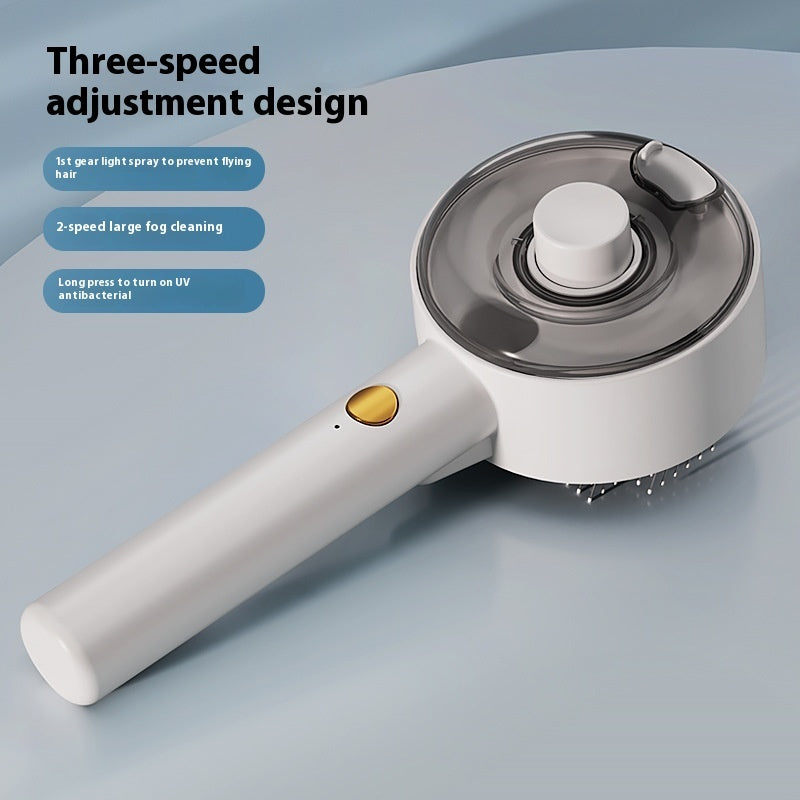White pet steam grooming brush with a gold button, translucent water tank, and three-speed UV antibacterial settings.