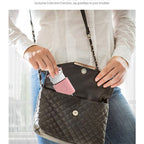 Pink silicone protective case for Apple 20W charger, featuring a wrap-around cord organizer held inside a handbag.