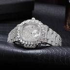 Iced-out silver-tone men's quartz watch fully encrusted with shimmering rhinestones on a textured black leather surface.