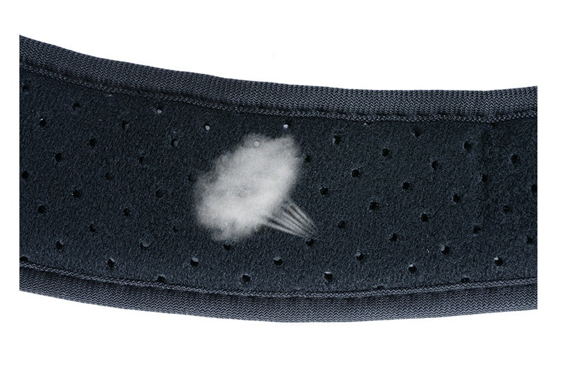 Close-up of a black, perforated, breathable fabric strap for a medical posture corrector with a steam graphic overlay.
