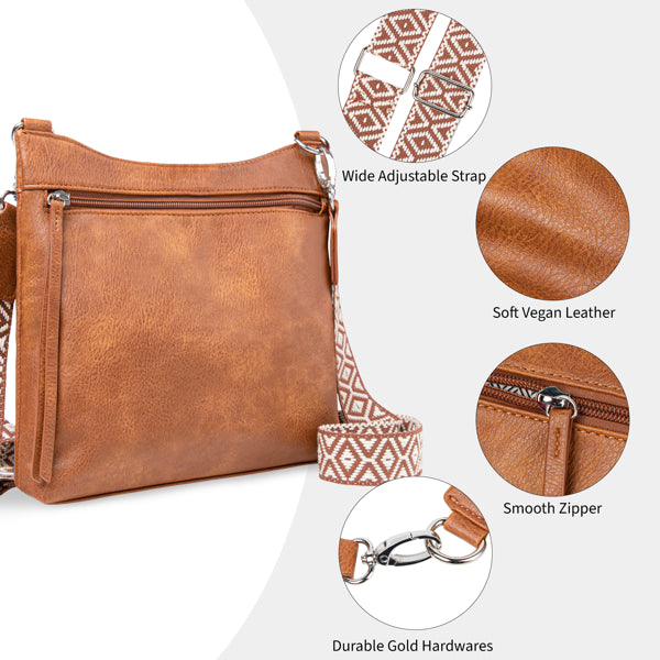 Brown vegan leather crossbody bag with a patterned adjustable strap, gold hardware, and multiple zippered pockets.