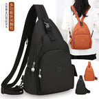 Black and orange waterproof nylon sling chest backpacks with multiple zipper pockets and adjustable straps for women.