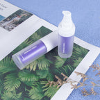 Two purple pump bottles of V34 colour corrector toothpaste on a botanical print magazine over a textured blue surface.