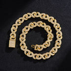 Gold-tone hip hop chain with an infinity-link design, fully encrusted in clear sparkling crystals on a black background.