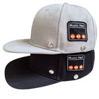 Grey and black baseball caps with side "Music Hat" Bluetooth control panels featuring playback buttons and silver rivets.