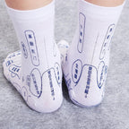 White cotton socks with blue printed acupressure reflexology charts and Chinese labels showing various foot points.