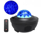 Black USB LED star projector lamp with remote control, casting a blue galaxy light effect on surfaces.
