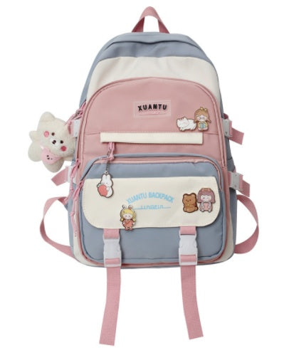 Korean-style pastel color-blocked backpack with utility buckles, plush charm, and cute character patches.