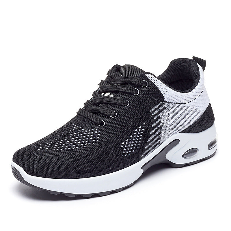 Women’s black and white knit fashion sneaker with lace-up closure and a thick, cushioned air-bubble sole.