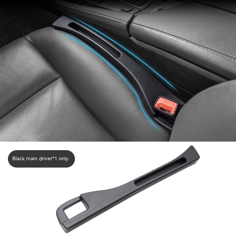 Black plastic car seat gap organizer installed between a leather seat and center console, with a seatbelt buckle cutout.