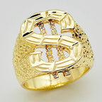 Gold-tone hip hop ring featuring a dollar sign symbol with a textured, hammered finish on a white background.