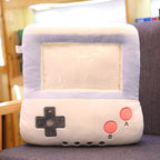 Plush, white-and-blue game console-shaped pillow with a clear center window and embroidered buttons for hand warming.