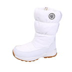 White mid-calf snow boot with quilted cotton upper, snowflake emblem, and a thick white sole with a brown tread.