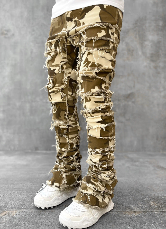 Men's camo-print stacked jeans featuring distressed, horizontal fringe rips and a tight, elongated fit.