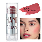 Matte rose blush stick in silver tube with swatch and model showing the shade on cheeks and lips.
