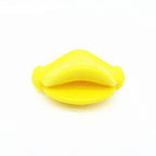 Bright yellow duck-bill shaped silicone baby pacifier, isolated on a white background.