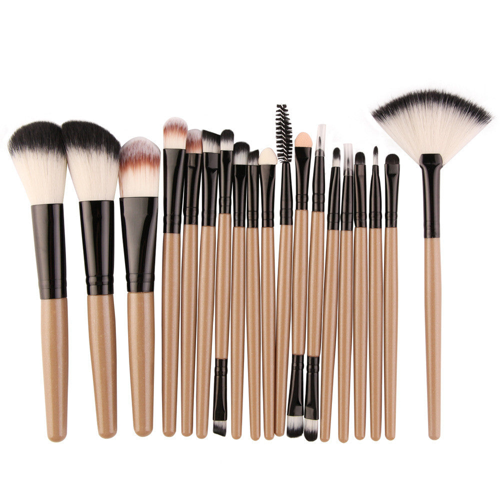 A set of makeup brushes with tan handles, black ferrules, and dual-toned synthetic bristles, including a fan brush.