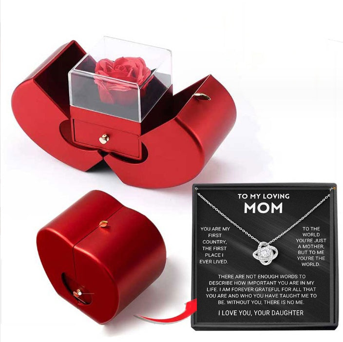 Red apple-shaped gift box containing an eternal rose and a "To My Loving Mom" necklace in a display box.