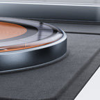 Close-up of a 3-in-1 magnetic wireless charger with a transparent circular coil design and matte gray base.