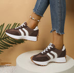 Women’s brown suede and fabric lace-up sneakers with white side stripes, white thick soles, and gum-colored tread.
